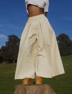 .. A forever wardrobe staple, the Khadijah Pant is a mid-high waisted wide leg pant. With double pleating cascading down the front of each pant leg, this voluminous detail takes on the illusion of a maxi skirt. The smooth waistband on the front fades into an elasticated one on the back. This detail is intended for a comfortable wear, while cinching your waist to ensure the proper fit. .. Mid-high waisted, wide leg pant .. Double pleating on each pant leg .. 2" smooth waistband on front, elastica Chic Cotton Pleated Wide Leg Pants, Chic Pleated Cotton Wide Leg Pants, Pleated Wide Leg Pants For Summer, Pleated Wide-leg Pants For Summer, Wide Leg Pants With Accordion Pleats, Pleated Summer Trousers, Summer Pleated Trousers, Cotton Wide-leg Pleated Pants, Pleated Cotton Wide-leg Pants