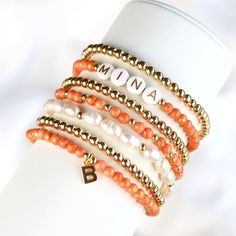 Do you want to give yourself or a loved one a lucky charm, then these bracelets are just right. The orange jade bracelet with the letter pendant and the gold-plated pearl bracelet are a noble combination and a real eye-catcher. You can wear the beautiful delicate bracelets individually or as a trendy combination. The stones are strung on a stretch band, so the bracelet is easy to slip over your hand. ❤ Handmade with love I High-quality I Lovely packaging ❤ DETAILS Mashan jade orange-gold colored (4 mm). Cultured pearls (6-7x5mm) Pendant brass 14k gold plated Brass beads 14k gold plated (does not ring) Elastic nylon strap ❤ Jade it is considered the stone of love and friendship and inner peace. PLEASE NOTE Since natural stone is used, each bead and bracelet is unique. ❤ You can find more pe Personalized Orange Round Bead Jewelry, Gift Stackable Pearl Bracelet With Round Beads, Stackable Pearl Bead Bracelet As A Gift, Stackable Pearl Bracelet With Round Beads As Gift, Stackable Round Bead Pearl Bracelet As Gift, Personalized Orange Beaded Bracelets As Gift, Personalized Orange Bracelets As Gift, Stackable Pearl Bracelet Gift, Orange Round Beads Jewelry For Everyday