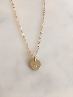 Hello, thank you for visiting my Loollery by Locket shop. Beautifully simple and elegant custom hand-stamped 14ct gold filled initial necklace. This necklace would make the perfect gift for a mother with her children's initials, as a bridesmaids present or as a gift for yourself. The polished 14ct gold filled disc is 9mm in size the letter size is 3mm finished with a 14ct gold filled plain trace chain. You can custom the length of chain as you desire (please select size option). Choose from 1-3 Dainty Hand Stamped 14k Gold Necklace, Gold Minimalist Initials Necklace, Dainty Gold Custom Necklace With Round Pendant, Simple Charm Necklace For Anniversary, Minimalist Yellow Gold Hand Stamped Charm Necklace, Gold Dainty Round Pendant Custom Necklace, Dainty Personalized Gold Custom Necklace, Gold Hand Stamped Charm Necklaces For Wedding, Dainty Hand Stamped Yellow Gold Necklaces