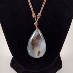 "The agate pendant is approximately 1.75 inches in length on natural light brown polished round leather. The necklace is adjustable from 16 inches to 32 inches by sliding the knots. Agate is a rock consisting primarily of cryptocrystalline silica, chiefly chalcedony, alternating with microgranular quartz. It is characterized by its fineness of grain and variety of color. Although agates may be found in various kinds of host rock, they are classically associated with volcanic rocks and can be com Brown Agate Casual Jewelry, Brown Adjustable Teardrop Pendant Jewelry, Casual Brown Agate Jewelry, Adjustable Brown Teardrop Necklace, Everyday Pendant, Metamorphic Rocks, Montana Agate, Unusual Earrings, Silver Earrings Handmade