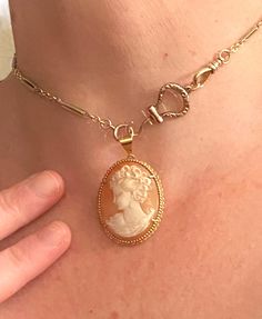 Beautiful vintage French-made cameo pendant in excellent vintage condition. This large and beautiful cameo has been delicately carved from pink shell and prong-set in gleaming 18k yellow gold. French hallmarks for 18k (eagle's head) and a maker's mark (unidentifiable) grace the back. A lovely and well-preserved example of the cameo trend of the 1950s and 60s. Ships in jewel box with ribbon, ready for gifting. Listing is for pendant only. Chain and other items sold separately. Box With Ribbon, Angel Pendant, Gold And Pink, Vintage Cameo, Cameo Pendant, Love Charms, Watch Chain, Jewel Box, Swaggy Outfits