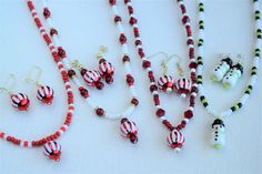 several beaded necklaces and earring sets on a table