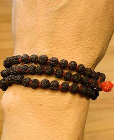 These Rudraksha malas can be worn on wrist or around the neck. Rudraksha beads are known for their healing properties and protective powers. By meditating with a rudraksha mala, it is believed to increase the ability to concentrate, giving clarity and peace of mind. Their size and texture make them great for promoting concentration during meditation.Rudraksha beads are known for their healing properties and protective powers. By meditating with a rudraksha mala, it is believed to increase the ab Hand Wrapped Mala With Round Beads For Meditation, Hand Wrapped Round Beads Mala For Meditation, Hand Wrapped Mala For Meditation, Spiritual Hand Knotted Bracelets With Round Beads, Handmade Spiritual Mala For Puja, Spiritual Round Beads Mala For Puja, Hand-strung Spiritual Mala For Puja, Spiritual Mala With Round Beads For Puja, Spiritual Mala For Puja With Round Beads