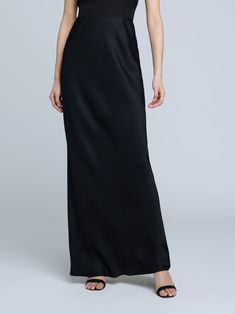 A stunning, understated maxi skirt in pure black. Bias-cut, silk-like fabric falls in a subtle, lustrous cling over the figure, enhancing and elongating the silhouette. Smooth elastic waist with no closures. Full Length Satin Finish Maxi Dress, Sleek Long Skirt For Night Out, Sleek Full-length Bias-cut Maxi Dress, Elegant Floor-length Satin Skirt, Chic Silk Maxi Dress For Black-tie Events, Chic Full Length Silk Maxi Skirt, Chic Full-length Silk Maxi Skirt, Evening Maxi Skirt With Satin Finish, Evening Satin Maxi Skirt With Satin Finish