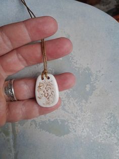 Handmade from Australian white stoneware clay. Hand painted design in soft brown. Pendant hangs on a waxed cord with slip knots and is adjustable from 42 - 46 cm ... can be adjusted so that you can wear it at the length that suits your body. Each tabbiestone pendant is the result of a combination of traditional and experimental techniques.  All necklaces are carefully packaged.  Perfect for gift giving! See our store for more colours and styles: www.etsy.com/shop/tabbiestone Thank you for browsi White Adjustable Earthy Necklace, White Adjustable Earthy Necklaces, Adjustable White Earthy Necklace, Adjustable White Earthy Necklaces, White Necklace With Adjustable Waxed Cord, Bohemian White Necklace With Adjustable Length, Adjustable White Hand Painted Necklaces, Adjustable White Hand Painted Necklace, Handmade White Jewelry With Waxed Cord