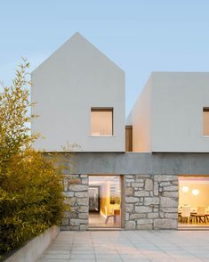 the house is made out of concrete and has two large windows on each side of it