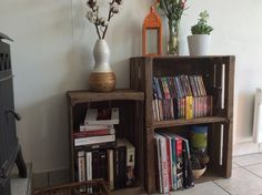 the bookshelf is made out of wooden crates