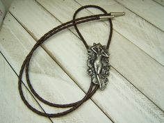 "- The Perfect gift for Her, Him, Yourself,...Christmas, Birthday, Anniversary, and more - Affordably Priced and always in style - Southwestern Western Boho Chic Bohemian Style Bolo Tie, - Silver Plate with Antique Finish, - Anti-Tarnish added for Lasting Beauty, - 36 TO 42 inch, Black or Brown, Vinyl Leather like Cord, - Silver Tone Cord End Tips, - Dimensions: Approx. 1.5 inches wide by 2.5 inches high, - \"Made In USA\", with Pride! - Wedding Neckties, Wedding Ties, Groomsmen Ties, - #80516-1 Soldier Boots, Pride Wedding, Western Boho Chic, Boots Art, Concert Wear, Military Soldier, Groomsmen Ties, Western Necklaces, Boho Chic Necklace