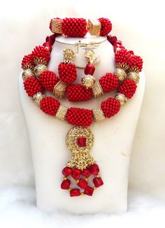 Elongated Beautiful Mixed Traditional Red Coral Style Beads Necklace African Nigerian Set Complete Set is Necklace Earring and bracelet. Comes with two styles earring. Beautifully designed by PrestigeApplause Wedding Party Bridal Special Occasion This detailed Jewellery set makes you stand out elegantly in any special occassion, it's all about glamour and uniqueness.  Buying more that 2 Jewellery set, we offer wholesale and bulk prices for all our jewellery. Handmade Red Coral Jewelry With Oval Beads, Handmade Oval Beads Red Coral Jewelry, Handmade Red Coral Oval Beads Jewelry, Red Coral Polished Beads For Jewelry Making, Traditional Red Coral Beads, Elegant Red Beaded Jewelry Set, Red Coral Round Beads For Jewelry Making, Red Polished Beads Jewelry Sets, Red Jewelry Sets With Polished Round Beads