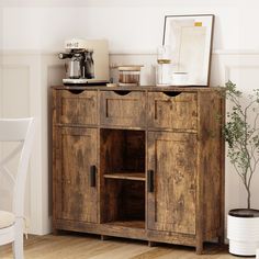 a wooden cabinet sitting next to a potted plant on top of a hard wood floor