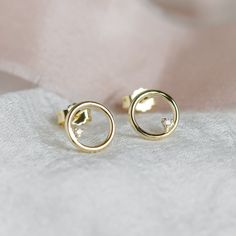 Circle stud earrings represent minimalist and elegant style. Delicate stud earrings are made for lovers of simple. Always remember that the simple things in life are often the most beautiful! Tiny diamond studs are made of solid 14K gold. Choose your colour of gold from the variations. DETAILED DESCRIPTION WiDTH                8mm METAL             Gold 14K WEIGHT                0,7g Diamond details Size - 2 x 1,25mm Carat weight - 0,015ct Handcrafted with love from our workshop in Prague.⚒ PACK Circle Stud Earrings, Circle Earrings Studs, Tiny Stud Earrings, Tiny Diamond, Circle Studs, Solid Gold Rings, Diamond Studs, Jewelry Earrings Studs, Jewelry Pieces