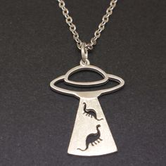 If you believe aliens exist million of years ago, this necklace is for you and you're a true UFO enthusiast. Base Material: 925 Sterling Silver  Size: 22mm X 29mm Chain Length: 16'' - 24'' Inches (Selectable) Metal Stamped: 925 Thickness: 1.5mm / 0.059 Inch You'll receive Order Shipped Email from us when your item is completed and shipped. SPECIAL ANNOUNCEMENT  1. Please visit https://www.etsy.com/shop/yhtanaff for more designs. 2. Subscribe our newsletter to receive a Coupon Code for 10% discou Silver Space-themed Jewelry Gift, Space-themed Sterling Silver Jewelry Gift, Themed Sterling Silver Nickel Free Necklaces, Themed Sterling Silver Nickel-free Necklace, Themed Sterling Silver Necklace In Silver, Themed Sterling Silver Necklace, Adjustable Themed Sterling Silver Necklace, Sterling Silver Novelty Necklace For Gift, Themed Sterling Silver Jewelry As Gift