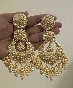 Tyaani inspired Ahmedabadi Kundan big Chand Bali in the Gold finish/Diamond Jhumki/Indian Jhumka/CZ Jhumka/Pakistani Jewelry/Celebrity Earring.  This designer charming Kundan big Chand Bali jhumka is neat and simple for those who wish for light jewelry. Match this jewelry with any of your outfits and flaunt your style. Luxury Gold Jhumkas For Navratri, Luxury Heavy Jhumkas For Diwali, Luxury Jeweled Chandbalis For Wedding, Luxury Heavy Chandbalis For Party, Luxury Chandbalis For Formal Occasions, Chandbali Jhumkas With Intricate Design For Navratri, Intricate Chandbali Jhumkas For Navratri, Navratri Chandbali Jhumkas With Intricate Design, Temple Jewelry Chandbali Jhumkas With Tilla