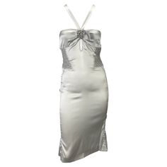 Presenting a beautiful silver silk ruched Gucci dress, designed by Tom Ford. From the Spring/Summer 2004 collection, this form-fitting dress features a Grecian-like neckline, keyhole cutout below the bust, and an exposed back. Ruched details add additional detail at the sides of the waist and back straps. This stunning silver dress is made complete with a silver tone rhinestone floral brooch at the bust-line. Approximate measurements: Size - IT40 31" bust 21" waist 34" hips 44" shoulder to hem 6 Fitted Silver Silk Dress, Luxury Fitted Silk Vintage Dress, Luxury Embellished Gucci Dresses, Fitted Silk Gucci Dress, Black Silk Gucci Dress, Vintage Gucci Dress Runway, Tom Ford For Gucci, Gucci By Tom Ford, Silk Summer Dress