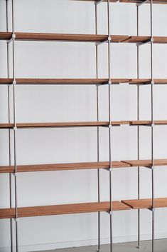 an empty book shelf with several wooden shelves