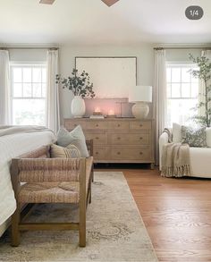 a bedroom with white walls and wooden floors