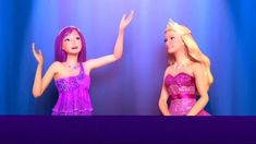 two barbie dolls standing next to each other in front of a blue curtain with lights