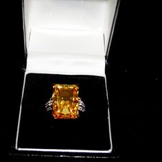 4.00ct Rectangular Octagonal Citrine Simulant Ring With 0.09ctw Round White Zircon Details At Sides. Solitaire Style. Prong Faceted. 18k Yellow Gold Over Sterling Silver. Size 7. Measures Approximately 3/4" Long And 1/2" Wide. Finished Under Gallery. New With Tags. Elegant Yellow Emerald-cut Diamond Ring, Elegant Yellow Emerald Cut Diamond Ring, Amber Yellow Sapphire Elegant Jewelry, Elegant Amber Jewelry With Yellow Sapphire, Amber Colored Yellow Sapphire Jewelry, Elegant Amber Topaz Ring, Elegant Yellow Rings With Diamond Accents, Elegant Emerald Cut Yellow Jewelry, Elegant Yellow Emerald Cut Jewelry