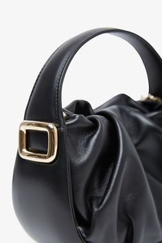 Black leather tote bag from Roger Vivier. The Viv' Choc hobo bag is made of nappa leather with a soft drape and can be carried by hand or crossbody with the removable shoulder strap. Measurements: L19 x H13.5 x W8 cmMade in Italy Leather Baguette Bag With Round Handle For Everyday, Leather Baguette Bag With Handles For Daily Use, Chic Bucket Bag With Adjustable Strap And Round Handle, Versatile Soft Leather Evening Bucket Bag, Leather Baguette Bag With Adjustable Strap And Double Handle, Travel Shoulder Bag With Soft Leather And Round Handle, Fall Faux Leather Hobo Bag With Detachable Strap, Chic Leather Baguette Bag With Handles, Leather Shoulder Baguette Bag With Handles