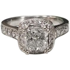 a square diamond ring with two rows of diamonds around the band and an intricate halo setting