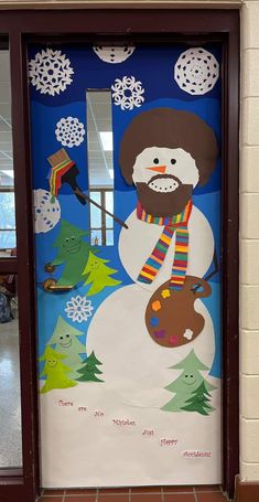 a door decorated with a snowman and christmas decorations