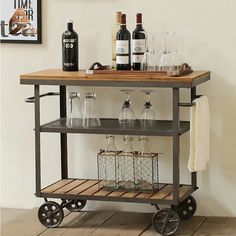 a bar cart with bottles and glasses on it