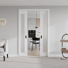 a living room filled with furniture and a clock mounted to the side of a wall