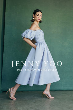 a woman in a blue dress posing for the cover of jenny yoo's magazine