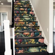 the stairs are decorated with flowers and plants on them, as well as wallpaper