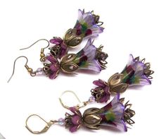 Boho earrings, flower earrings. Hand painted and color sealed (permanent) lilac purple flower earrings with a splash of olive green, burgundy and purple with lilac purple crystal accent beads. Dressed up or down no matter the occasion these colorful flower earrings are sure to compliment you. Earrings are large and lightweight and can be worn comfortably all day long. Earrings are recommended to those that are accustomed to wearing large earrings. Please refer to dimensions in description and ph