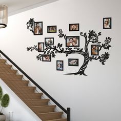 a family tree wall decal with pictures on it and stairs leading up to the second floor