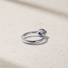 a ring sitting on top of a white surface