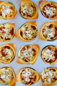 mini pizzas with cheese and sauce are in the muffin tins ready to go into the oven