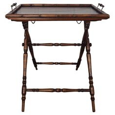 an old wooden table with two trays on each end and one shelf below it