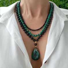 Black onyx and malachite crystal layered necklace with pendant. Chunky statement natural gemstone beaded necklace for women. Large black green handmade necklace with big bead and gemstone. Big bold bohemian bright necklace in gold color are suitable for an casual look, evening look and for a holiday. These necklace will be a good Mothers day, anniversary, wedding or birthday gift for women, mom, wife, girlfriend, sister or daughter. Women's necklace with natural stone. It emphasizes the beauty o Luxury Elegant Green Onyx Beaded Necklace, Elegant Gemstone Beads Necklaces For Layering, Elegant Beaded Necklaces With Natural Stones For Layering, Elegant Handmade Double Strand Crystal Necklaces, Elegant Handmade Double Strand Crystal Necklace, Elegant Handmade Crystal Necklace For Layering, Elegant Onyx Crystal Necklaces With Natural Stones, Elegant Agate Crystal Necklace With Faceted Beads, Black Double Strand Bohemian Jewelry