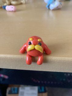 a toy crab sitting on top of a wooden table