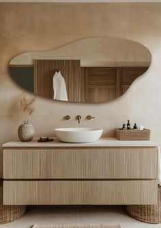 a bathroom with a large mirror above the sink