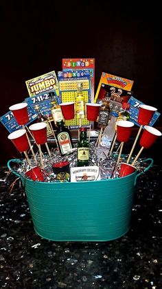 a bucket filled with drinks and snacks on top of a table