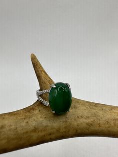 vintage green fun jade ring  Setting is a silver finished bronze setting  This is one of my hand re finished treasures. Salvaged from vintage.  Size  7 Re sizing can be done for a $20 fee and may take up to a week.  Engraving is $4 per letter.  Thank you for supporting a veteran's small business. All jewelry is shipped free within the US in a stylish gift box Oval Emerald Ring With Diamond Gemstone Accents, Formal Green Ring With Large Stone, Formal Oval Jade Emerald Ring, Emerald Oval Cabochon Gemstone Rings, Formal Oval Emerald Ring With Gemstone Accents, Oval Green Diamond Gemstones, Green Rings With Large Oval Cabochon Stone, Green Oval Cabochon Ring With Large Stone, Green Oval Stone Setting Rings