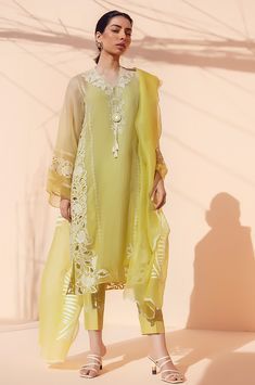 This lemon yellow ombre organza kurta exhudes elegance with floral embroidery and cutwork detailing. The look is completed with matching trousers and an organza dupatta with scallop detailing. Elegant Yellow Silk Salwar Kameez, Spring Anarkali Set With Cutwork, Summer Organza Kurta For Designer Wear, Summer Festive Organza Kurta, Summer Salwar Kameez With Organza Dupatta, Summer Organza Salwar Kameez With Dupatta, Summer Organza Lawn Suit With Dupatta, Summer Lawn Suit With Sheer Dupatta, Elegant Yellow Salwar Kameez With Intricate Embroidery