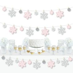 snowflakes and cupcakes are hanging from a string with white frosting