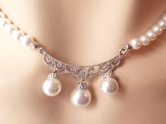 "Elegant, one of a kind bridal necklace and earring set made with 5mm Swarovski crystal core pearls and finished with a delicate .925 sterling silver centerpiece set with delicate cubic zirconia jewels and 8-10mm pearl drops. The necklace length is adjustable from 15.5\"-17.5\". The center focal piece is is 1.5\" wide and 1\" long. The earrings are .75\" long. OOAK, shipped in a free gift box! We have more sterling silver here: https://www.etsy.com/shop/dalfiya?section_id=17442255 We present our Victorian Bridal Necklace, Silver Centerpiece, Wedding Jewelry Sets, Crystal Pearls, Bridal Necklace, Wedding Classic, Earring Set, Jewelry Sets, Swarovski Crystals