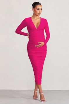 Elevate your maternity wardrobe in our gorgeous Renee midi dress. Cut from our signature stretch-jersey fabric that will contour your curves. this dress in a striking hot pink will be your go-to outfit for that special occasion. With full-body ruching. long sleeves. and a plunge twist neckline. this midi dress is designed to sculpt your bump and make a statement. Turn heads in our unmissable Renee maternity dress.FeaturesPlunge necklineTwist front detailLong sleevesDouble lined for comfort and s Maternity Wardrobe, Club L London, Maternity Midi Dress, Pregnancy Wardrobe, Christmas Party Dress, Dress With Long Sleeves, Information Design, Maternity Dress, Twist Front