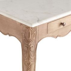 a white marble topped table with drawers