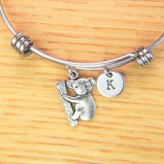 ♥ Koala Bear Charm Bangle Koala Bracelet Koala Charm Bracelet Koala Gift Animal Charm Personalized Initial Bangle Australia Bear Gift ♥ This is a silver-tone Koala Bear charm with hand stamped initial charm on an expandable bangle. ♥ You will receive 1 bangle ♥ Koala Charm 19.3x14,5x2 mm. ♥ Initial charm stainless steel 10mm choose from a drop-down menu. ♥ Bangle 57-64 mm ♥ additional initial https://www.etsy.com/listing/766732811 ♥ We strive for next day shipping, but we do not ship on Saturday Novelty Metal Charm Bracelet As Gift, Novelty Metal Charm Bracelet Gift, Adjustable Novelty Jewelry For Personalized Gifts, Adjustable Nickel-free Charm Bracelet As Gift, Adjustable Nickel-free Charm Bracelet Gift, Personalized Novelty Charm Bracelet, Silver Animal Design Jewelry For Gifts, Cute Adjustable Bangle Jewelry, Silver Jewelry With Animal Design For Gift