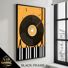 a black frame hanging on the wall next to a window with an image of a record player