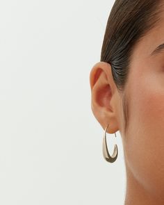 These exquisite pull-through teardrop earrings, measuring 24mm x 18mm with a 9mm opening, add an elegant touch to any look. Their distinctive shape and ideal size offer both style and comfort. Suited for any occasion, they enhance casual wear and elegantly complement dressy events, adding a touch of luxury at a great value. Materials 14K yellow gold or white gold plated. s925 Sterling Silver Posts. Measurements: Length: 24mm x 18mm; Opening: 9mm. Hypoallergenic; nickel, lead, and cadmium free. Elegant Pierced Teardrop Earrings, Metal Drop Hoop Earrings, Elegant Silver Teardrop Wrap Earrings, Trendy Teardrop Metal Hoop Earrings, Elegant Pierced Teardrop Pendant, Sleek Metal Drop Earrings, Modern Hypoallergenic Teardrop Jewelry, Chic Teardrop Earrings Tarnish Resistant, Modern Teardrop Wrap Earring (single)