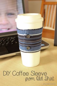 a coffee cup sitting next to a laptop computer on a table with the words diy coffee sleeve from old shirt