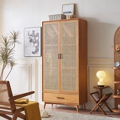 a wooden cabinet sitting next to a chair on top of a rug in a living room