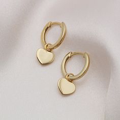 Heart of Gold. These cute little heart huggie hoop earrings will make the perfect addition to any jewellery collection. Whether there is a special someone in your life whom you wish to treat or need a little pick me up, these earrings are perfect. They are complete with a secure click-in fastening for wearing day and night. Hoop Diameter: 13mm Total Height: 20mm 925 Sterling Silver and 18ct Gold Vermeil Your item will come packaged in a lovely gift box for an added special touch. Unfortunately, Minimalist Heart-shaped Huggie Earrings For Everyday, Minimalist Heart Shaped Huggie Earrings For Everyday, Valentine's Day Heart Charm Huggie Earrings For Anniversary, Valentine's Day Heart Charm Huggie Earrings, Valentine's Day Huggie Earrings With Heart Charm, Dainty Heart-shaped Tarnish-resistant Huggie Earrings, Everyday Minimalist Heart Huggie Earrings, Gold Huggie Earrings For Valentine's Day, Dainty Tarnish Resistant Hoop Earrings For Valentine's Day